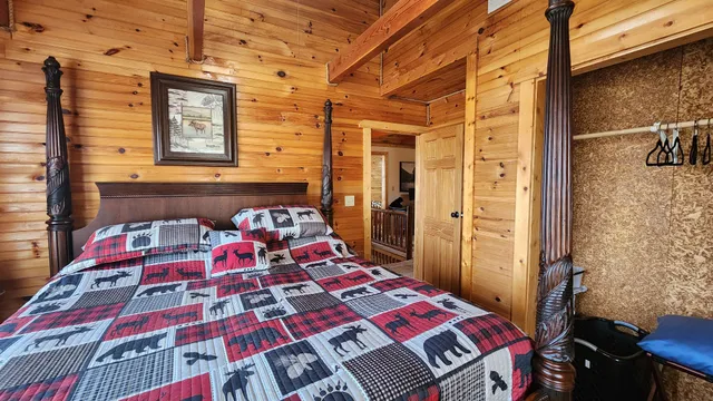 a bed sitting in a bedroom next to a bathroom