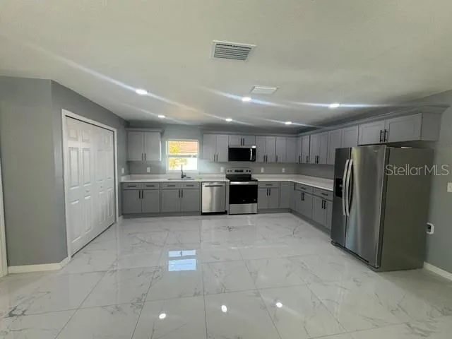a view of a livingroom with a ceiling fan and window