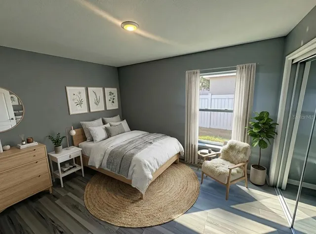 a bedroom with a bed and wooden floor