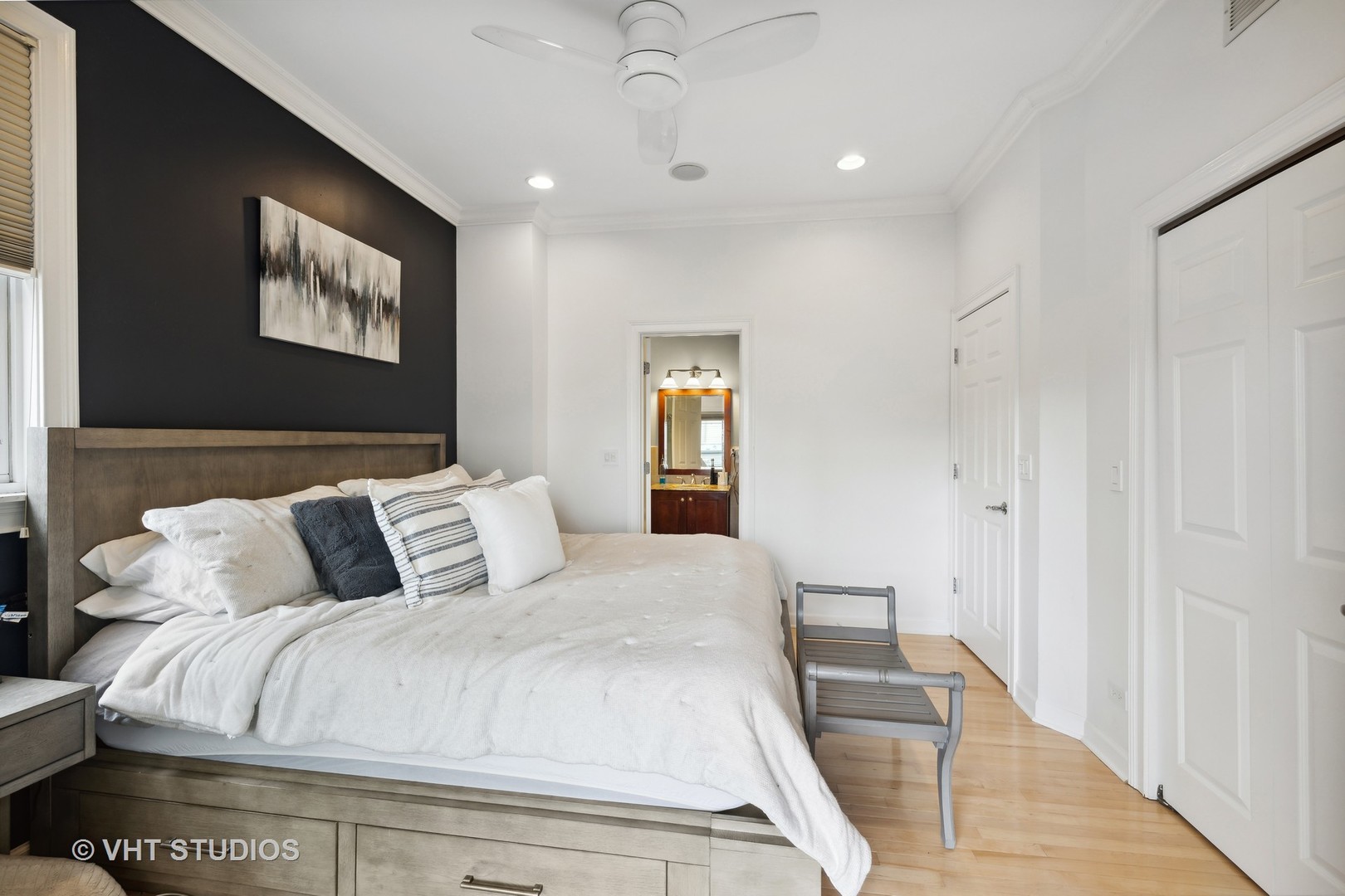 2128 West Walton Street, Unit 1E Chicago, IL 60622 - Photo 11 of 23 a bedroom with a large bed and a chandelier