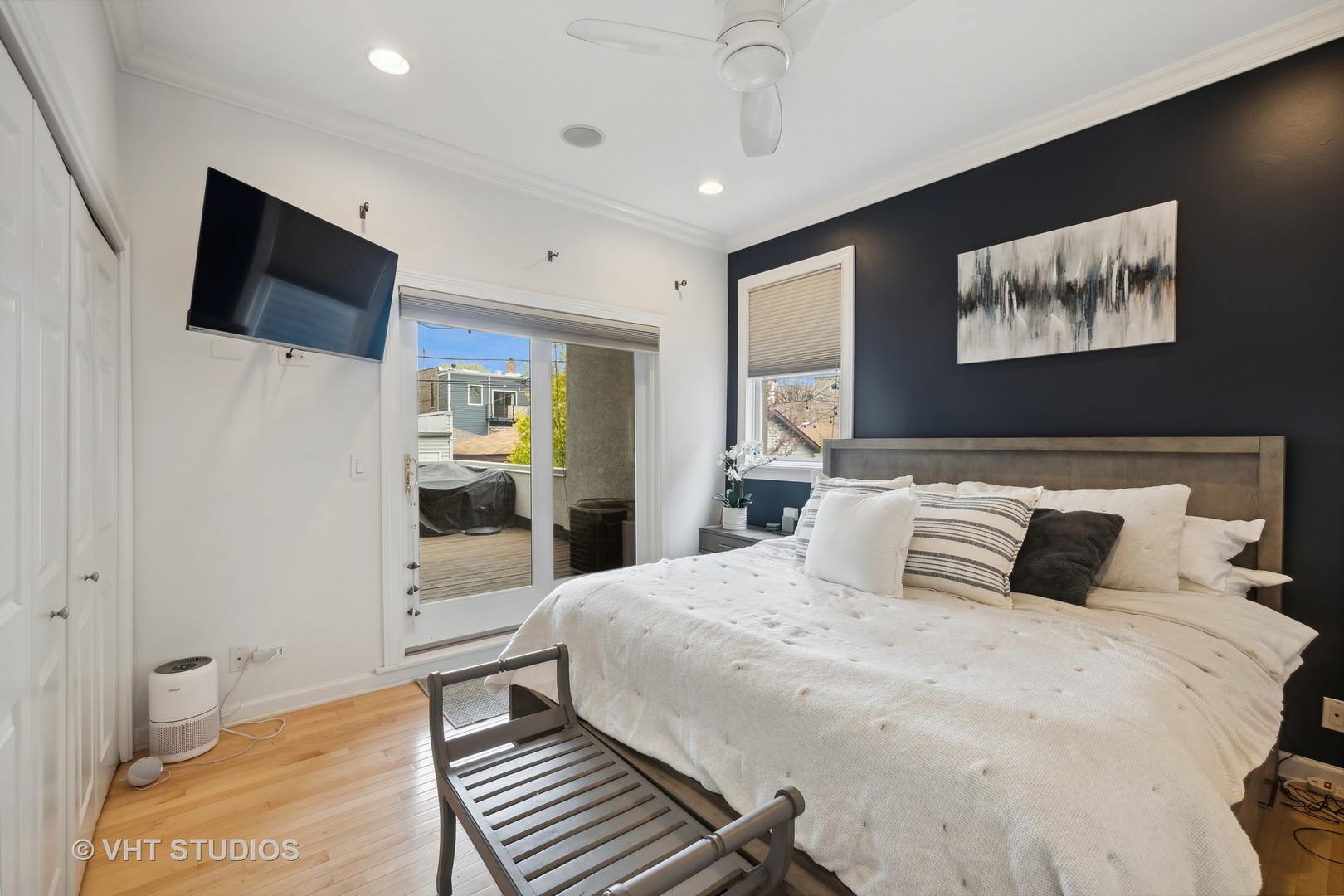 2128 West Walton Street, Unit 1E Chicago, IL 60622 - Photo 10 of 23 a bedroom with a bed and a flat screen tv