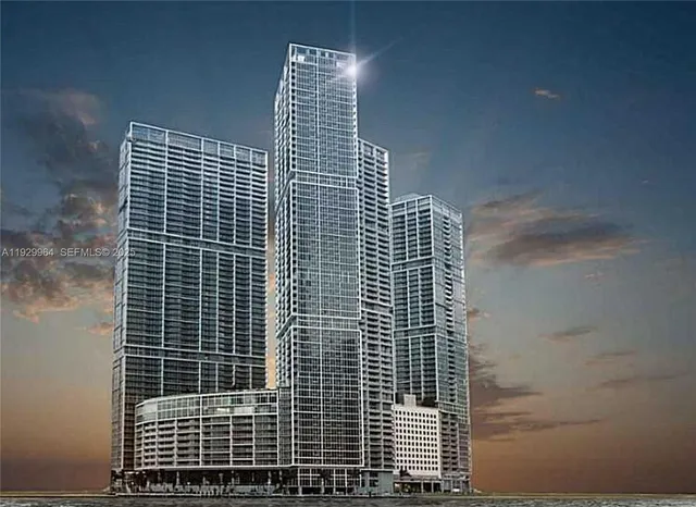 a living room with stainless steel appliances kitchen island a sink and a refrigerator