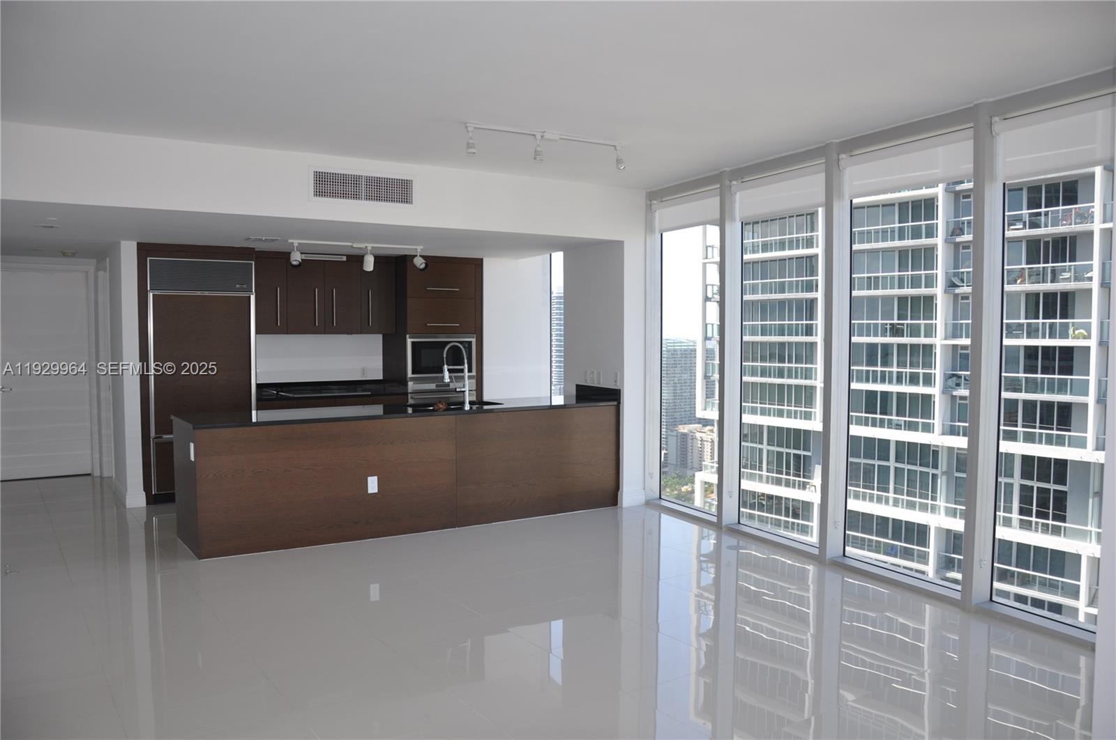 475 Brickell Avenue, Unit 4215 Miami, FL 33131 - Photo 3 of 17 a view of kitchen with refrigerator and window