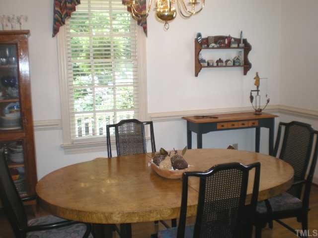 2300 Countrywood Road North Raleigh, NC 27615 - Photo 2 of 12 Dining Room has beautiful hardwood flooring, crown molding, and chair rail plus 2 windows. Dining Room