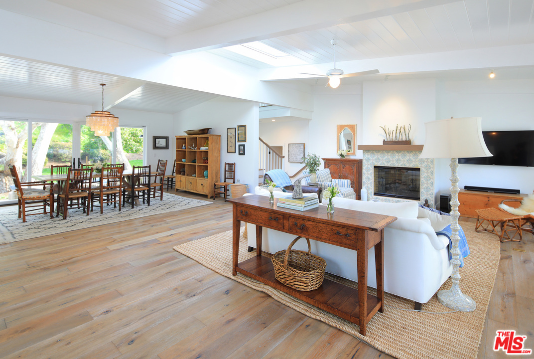 6152 Bonsall Drive Malibu, CA 90265 - Photo 13 of 26 a living room with furniture a fireplace and a flat screen tv