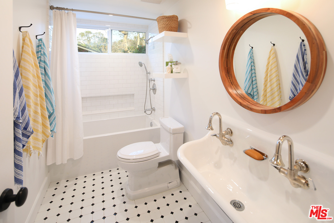 6152 Bonsall Drive Malibu, CA 90265 - Photo 20 of 26 a bathroom with a sink a toilet and a mirror