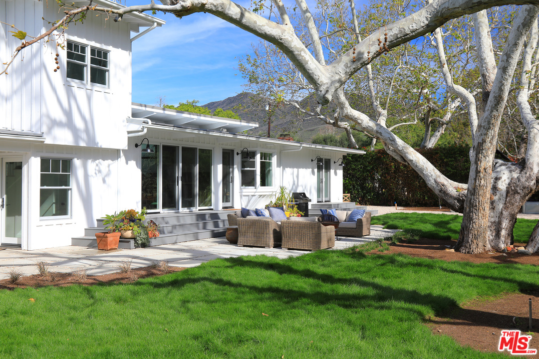 6152 Bonsall Drive Malibu, CA 90265 - Photo 21 of 26 a view of a house with backyard sitting area and garden