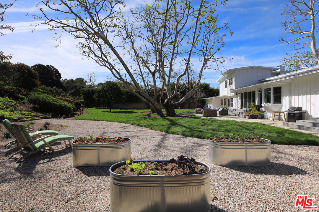 6152 Bonsall Drive Malibu, CA 90265 - Photo 9 of 26 a view of a patio with chairs and plants