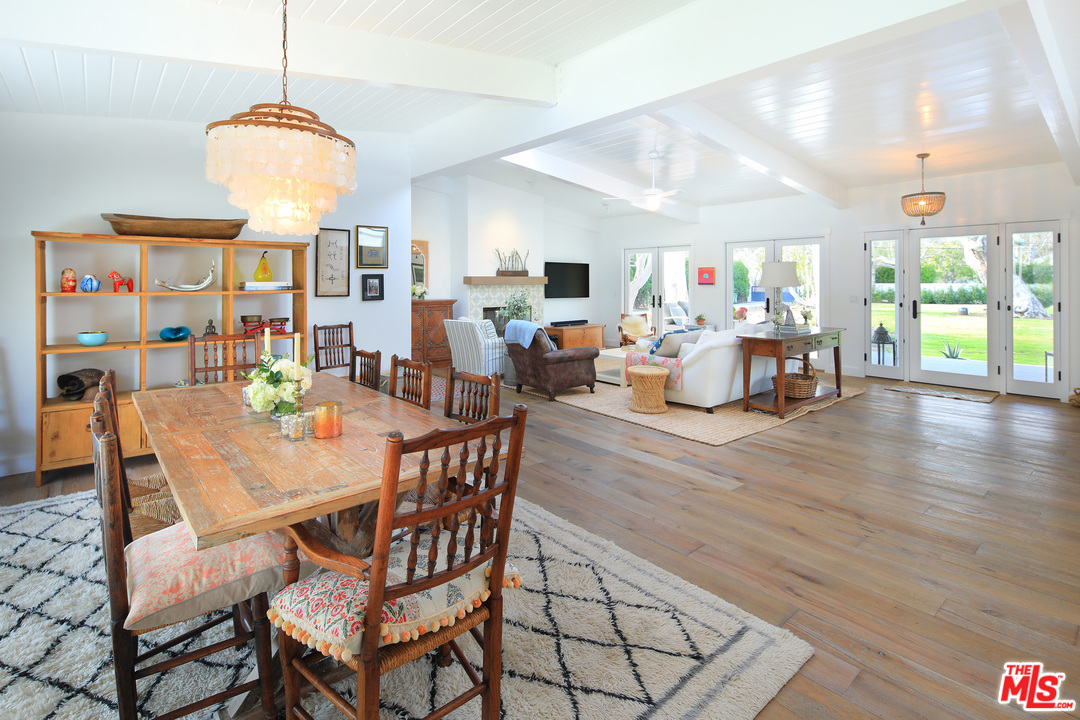 6152 Bonsall Drive Malibu, CA 90265 - Photo 10 of 26 a view of a dining room with furniture window and wooden floor