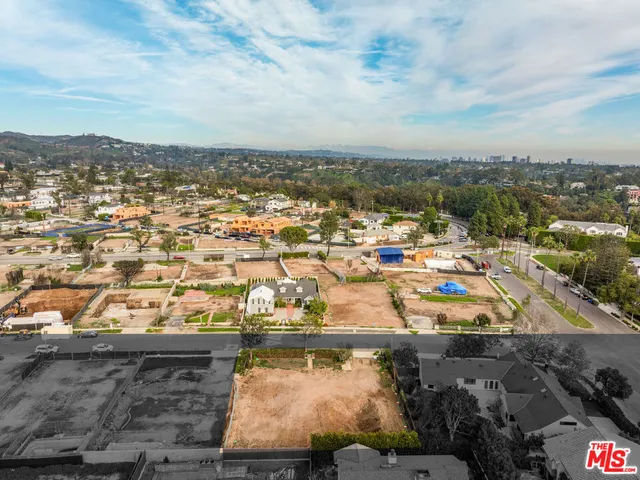 an aerial view of residential building and ocean view in back