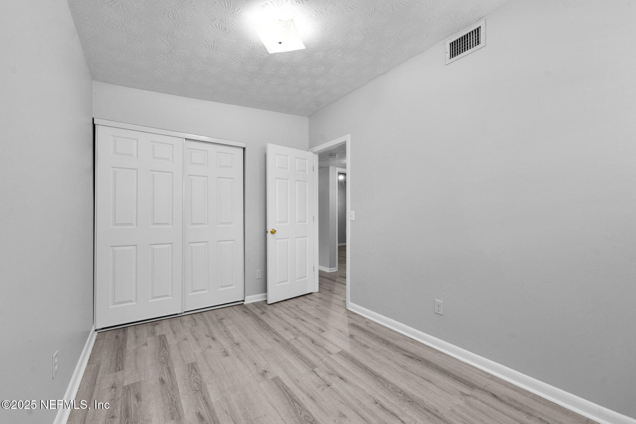 2254 Firestone Road Jacksonville, FL 32210 - Photo 11 of 20 a view of an empty room with wooden floor