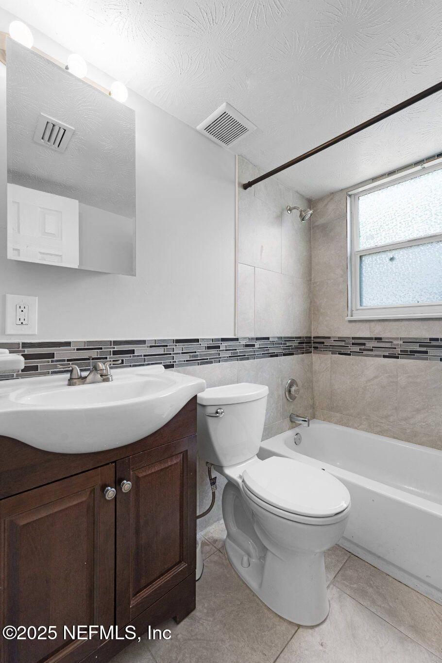 2254 Firestone Road Jacksonville, FL 32210 - Photo 16 of 20 a bathroom with a sink a toilet and a bathtub