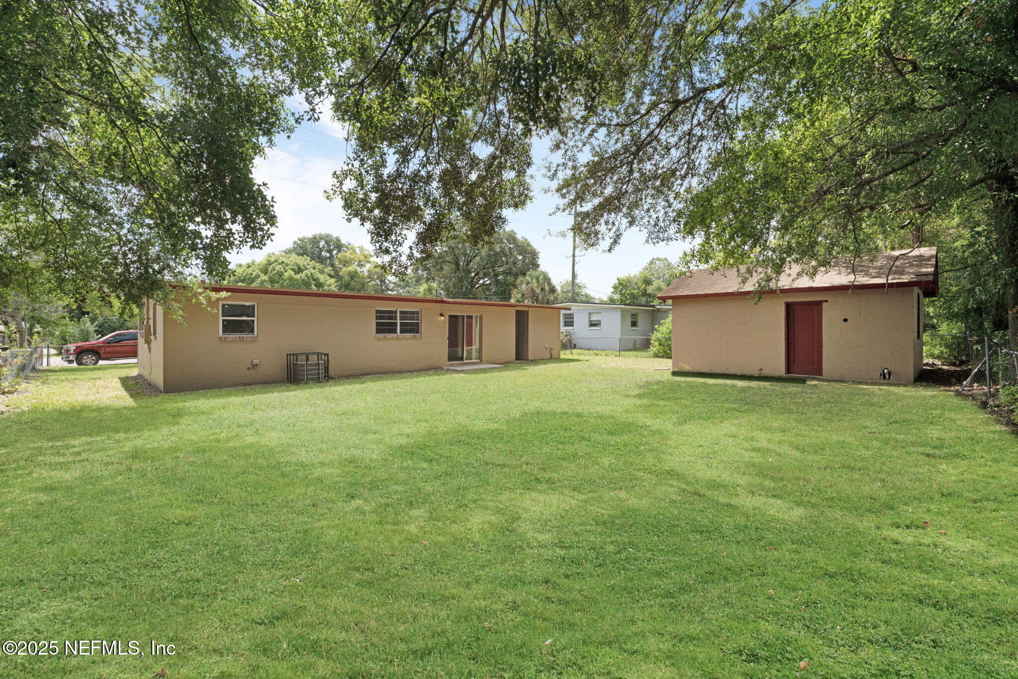 2254 Firestone Road Jacksonville, FL 32210 - Photo 20 of 20 a view of a backyard with a garden and tree