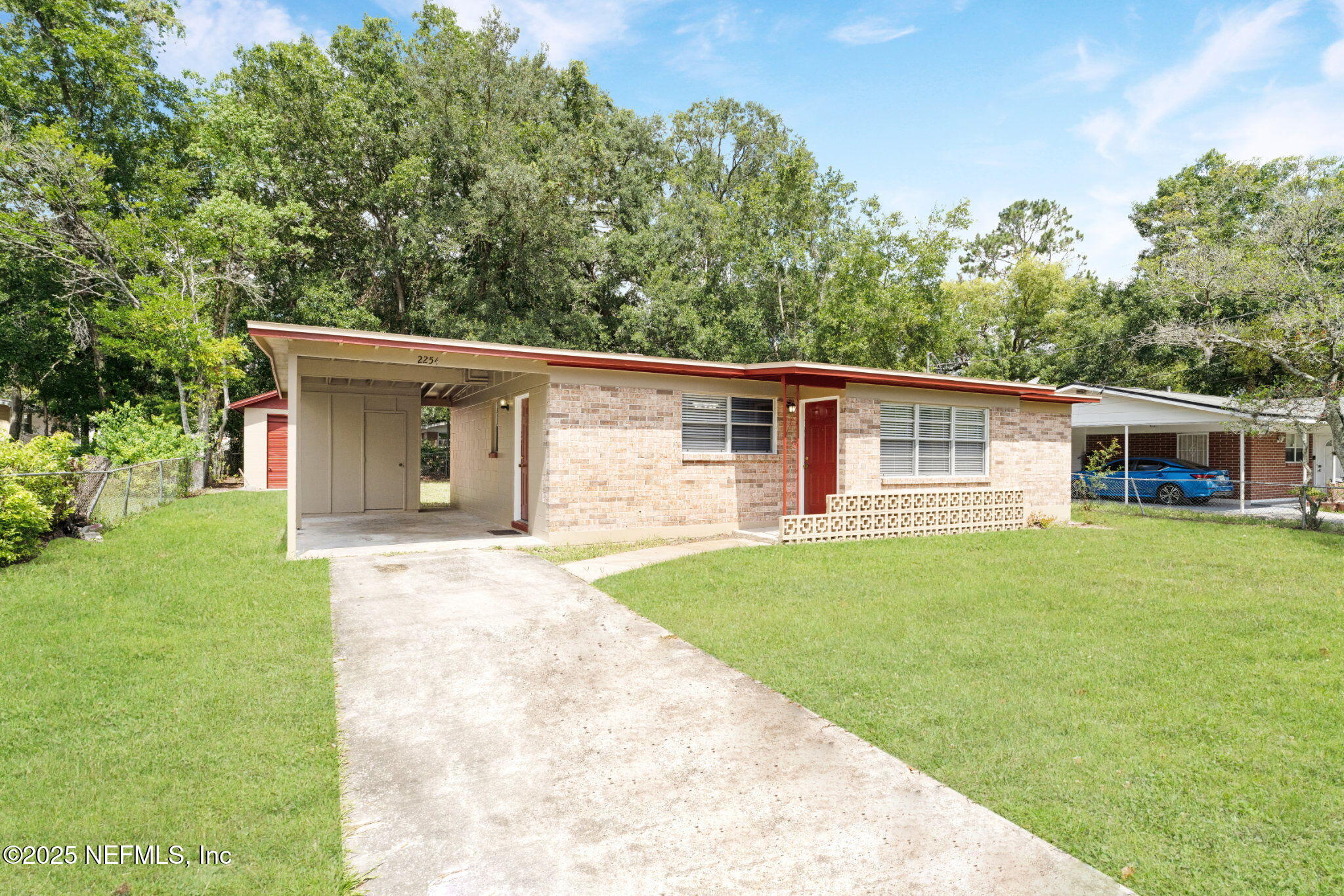 2254 Firestone Road Jacksonville, FL 32210 - Photo 2 of 20 a front view of a house with a garden