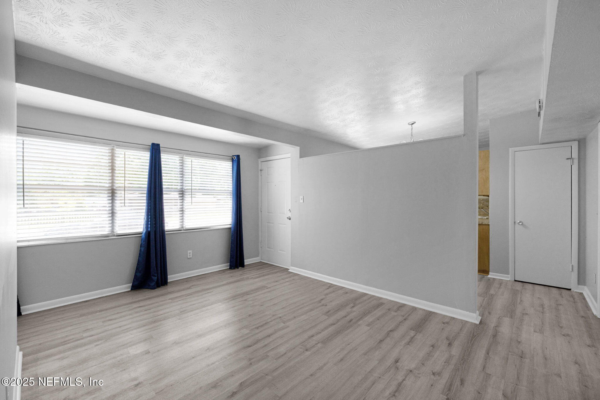 2254 Firestone Road Jacksonville, FL 32210 - Photo 4 of 20 wooden floor in an empty room with a window