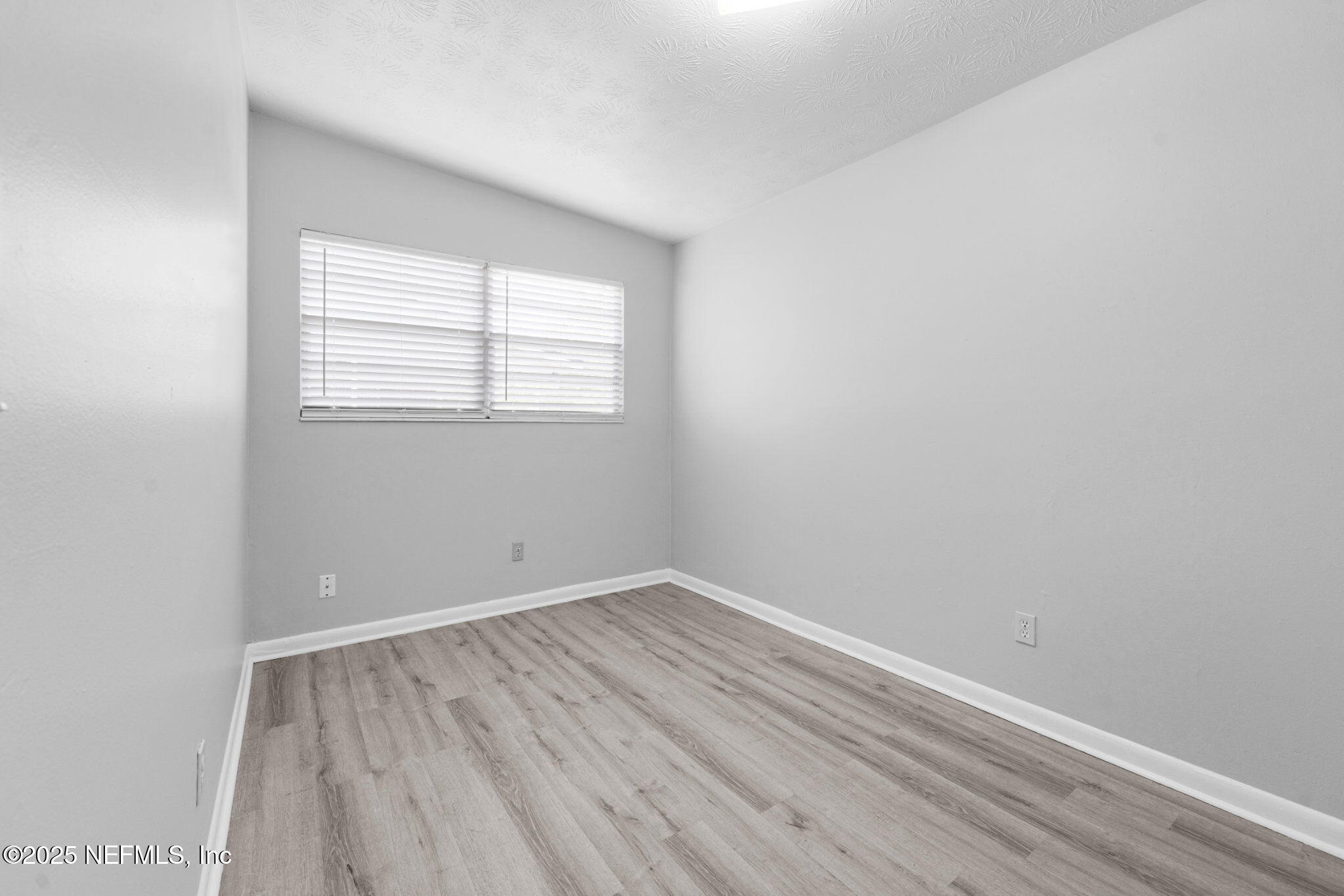 2254 Firestone Road Jacksonville, FL 32210 - Photo 10 of 20 an empty room with a window