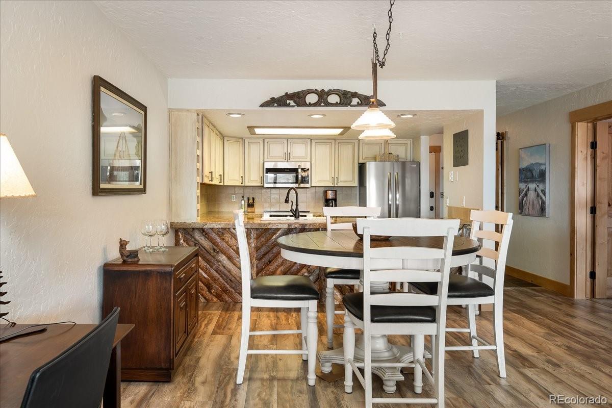605 Lake Front Road, Unit 8 Grand Lake, CO 80447 - Photo 11 of 30 a view of a dining room with furniture and wooden floor