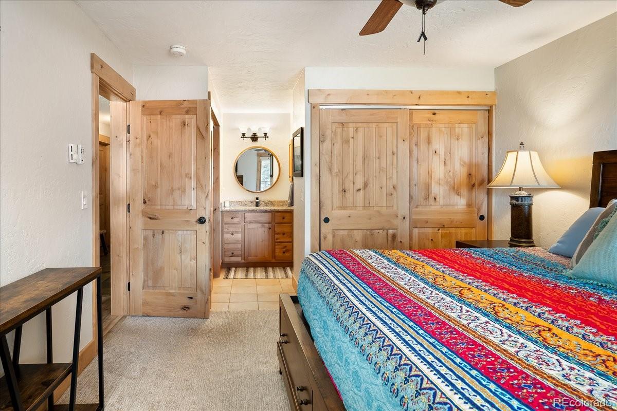 605 Lake Front Road, Unit 8 Grand Lake, CO 80447 - Photo 16 of 30 a bedroom with bed and a chandelier