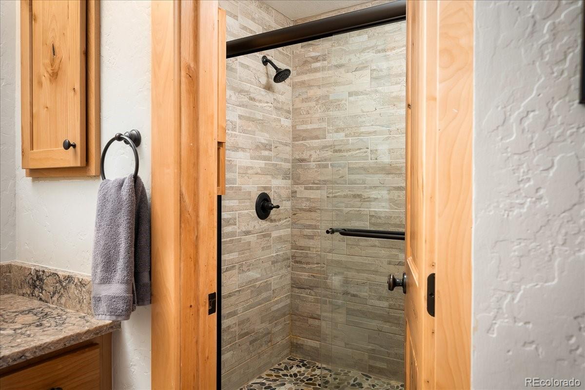 605 Lake Front Road, Unit 8 Grand Lake, CO 80447 - Photo 20 of 30 a bathroom with a shower and a sink
