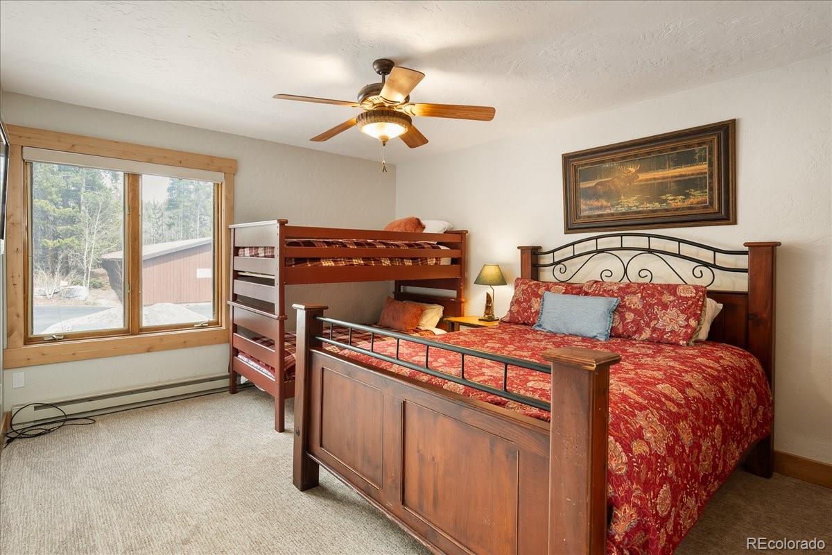 605 Lake Front Road, Unit 8 Grand Lake, CO 80447 - Photo 21 of 30 a bedroom with a bed and wooden floor