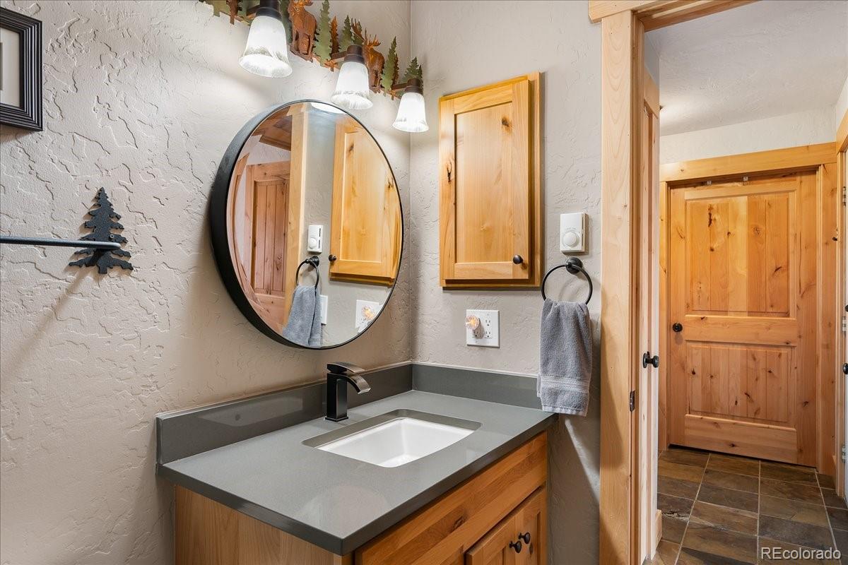 605 Lake Front Road, Unit 8 Grand Lake, CO 80447 - Photo 23 of 30 a bathroom with a sink a vanity and a mirror