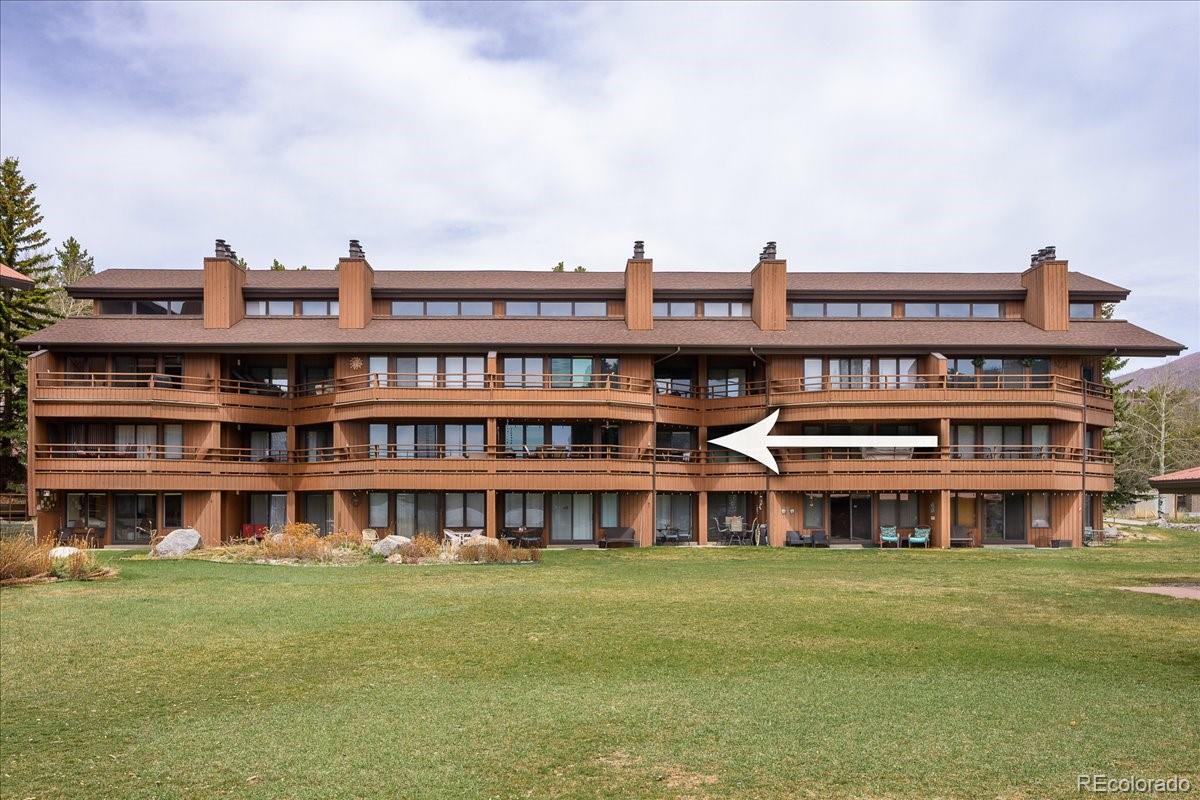 605 Lake Front Road, Unit 8 Grand Lake, CO 80447 - Photo 26 of 30 a view of a large building with a big yard and sitting area