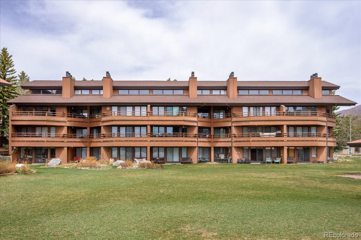 605 Lake Front Road, Unit 8 Grand Lake, CO 80447 - Photo 30 of 30 a view of a large building with a big yard and large trees