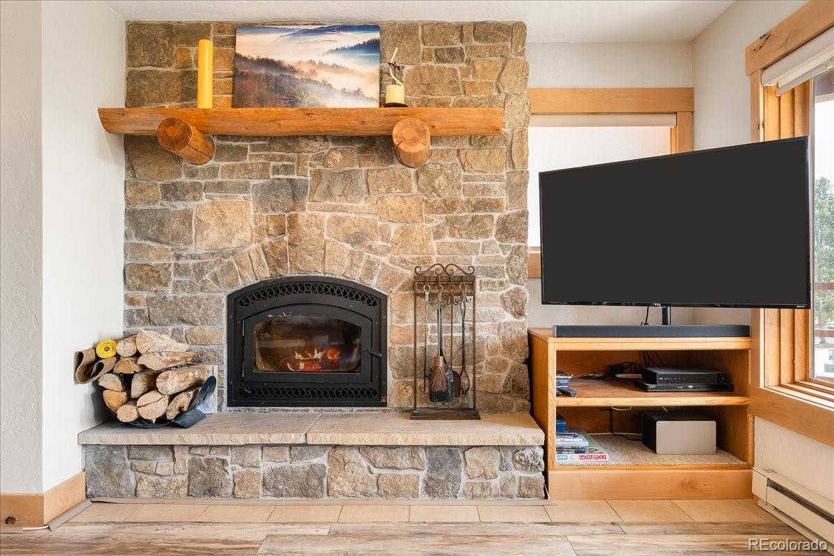 605 Lake Front Road, Unit 8 Grand Lake, CO 80447 - Photo 9 of 30 a living room with a fireplace a flat screen tv and a fireplace