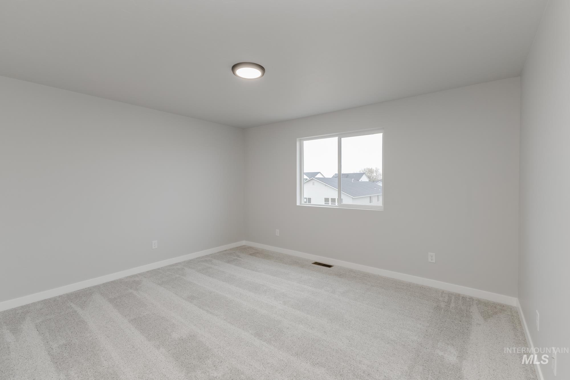 13743 Judson Street Caldwell, ID 83607 - Photo 12 of 23 Carpeted spare room featuring baseboards