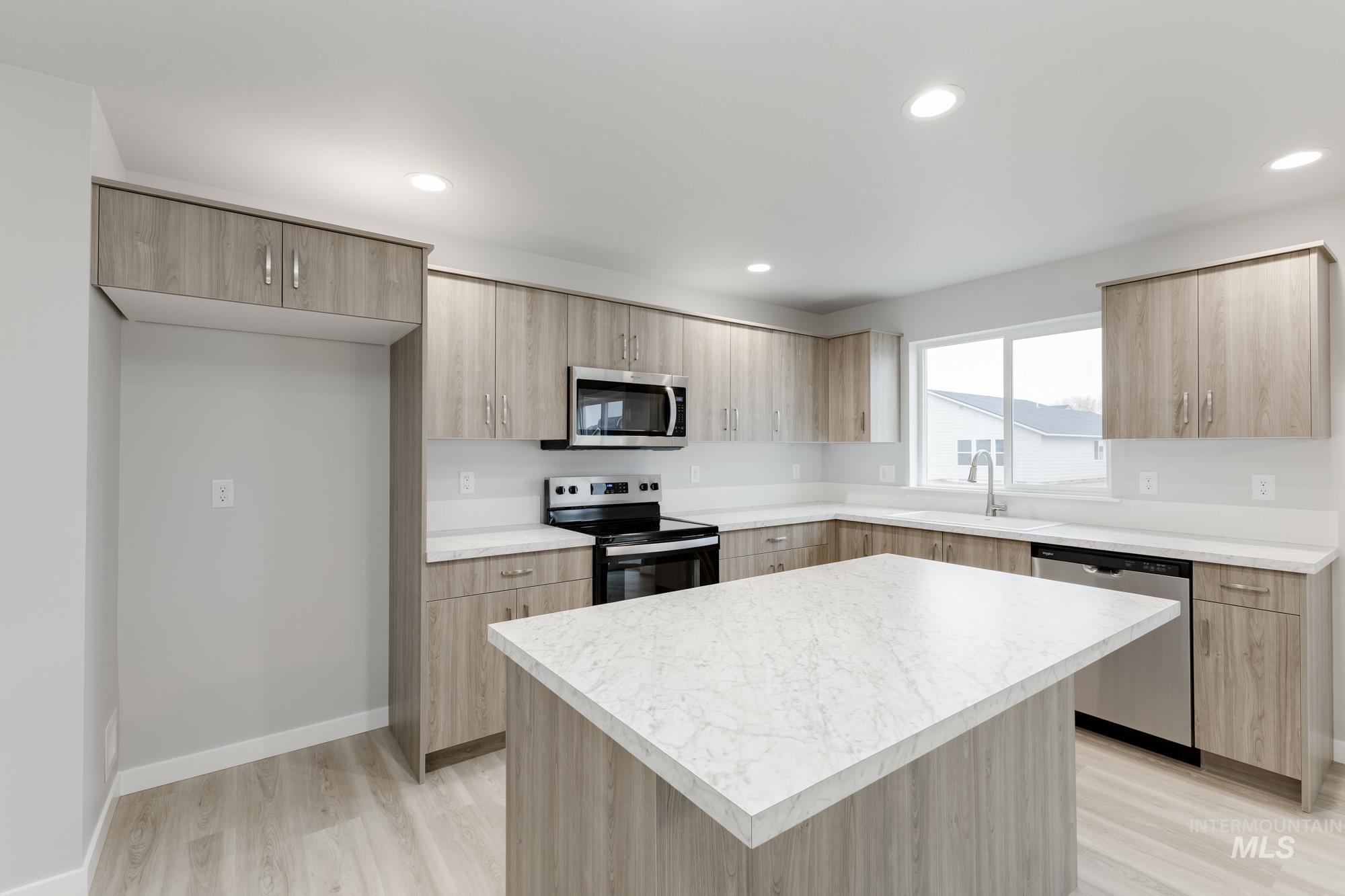 13743 Judson Street Caldwell, ID 83607 - Photo 3 of 23 Kitchen with stainless steel appliances, light brown cabinets, modern cabinets, and recessed lighting