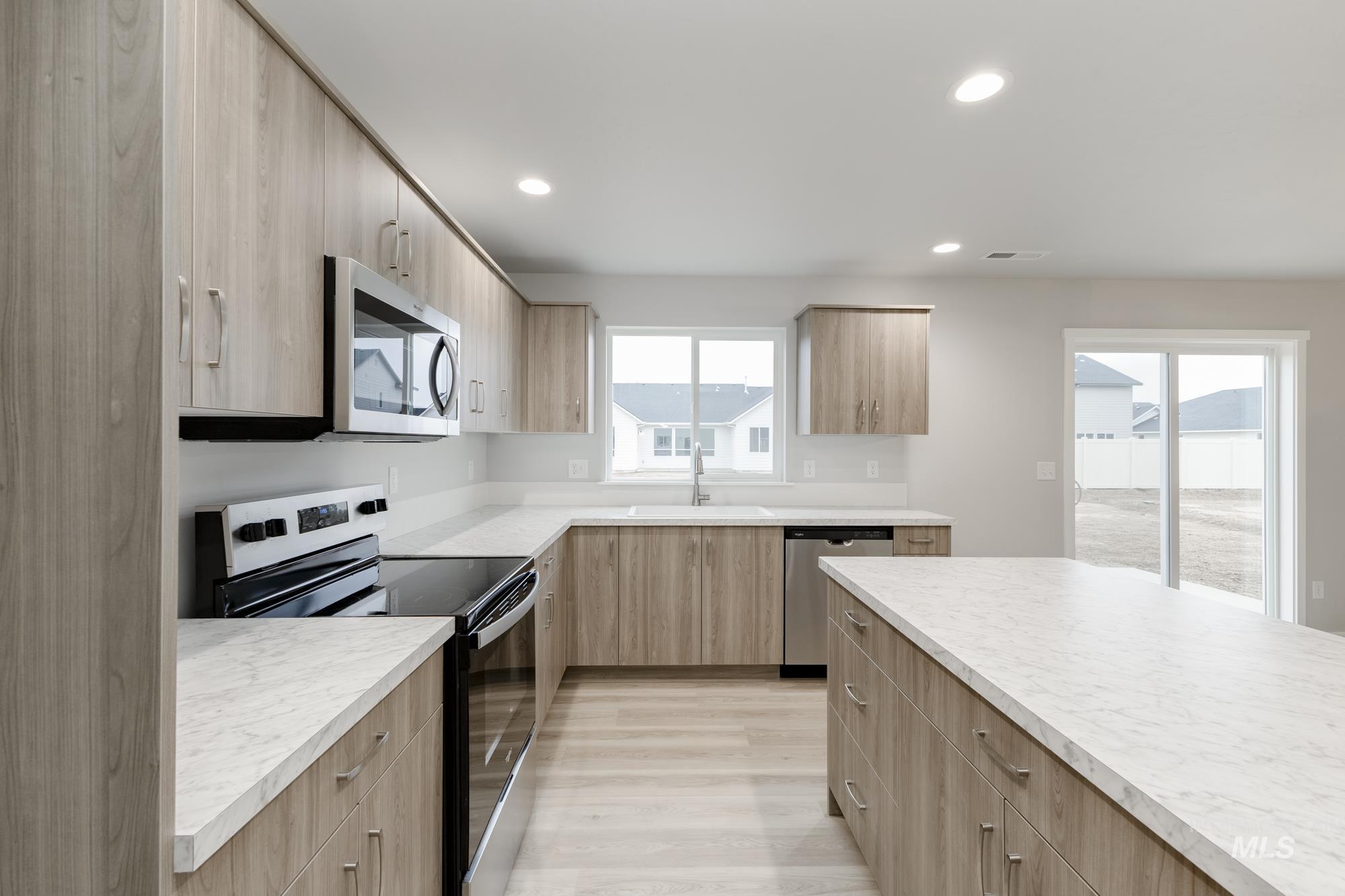 13743 Judson Street Caldwell, ID 83607 - Photo 5 of 23 Kitchen with appliances with stainless steel finishes, modern cabinets, light countertops, recessed lighting, and light wood-type flooring