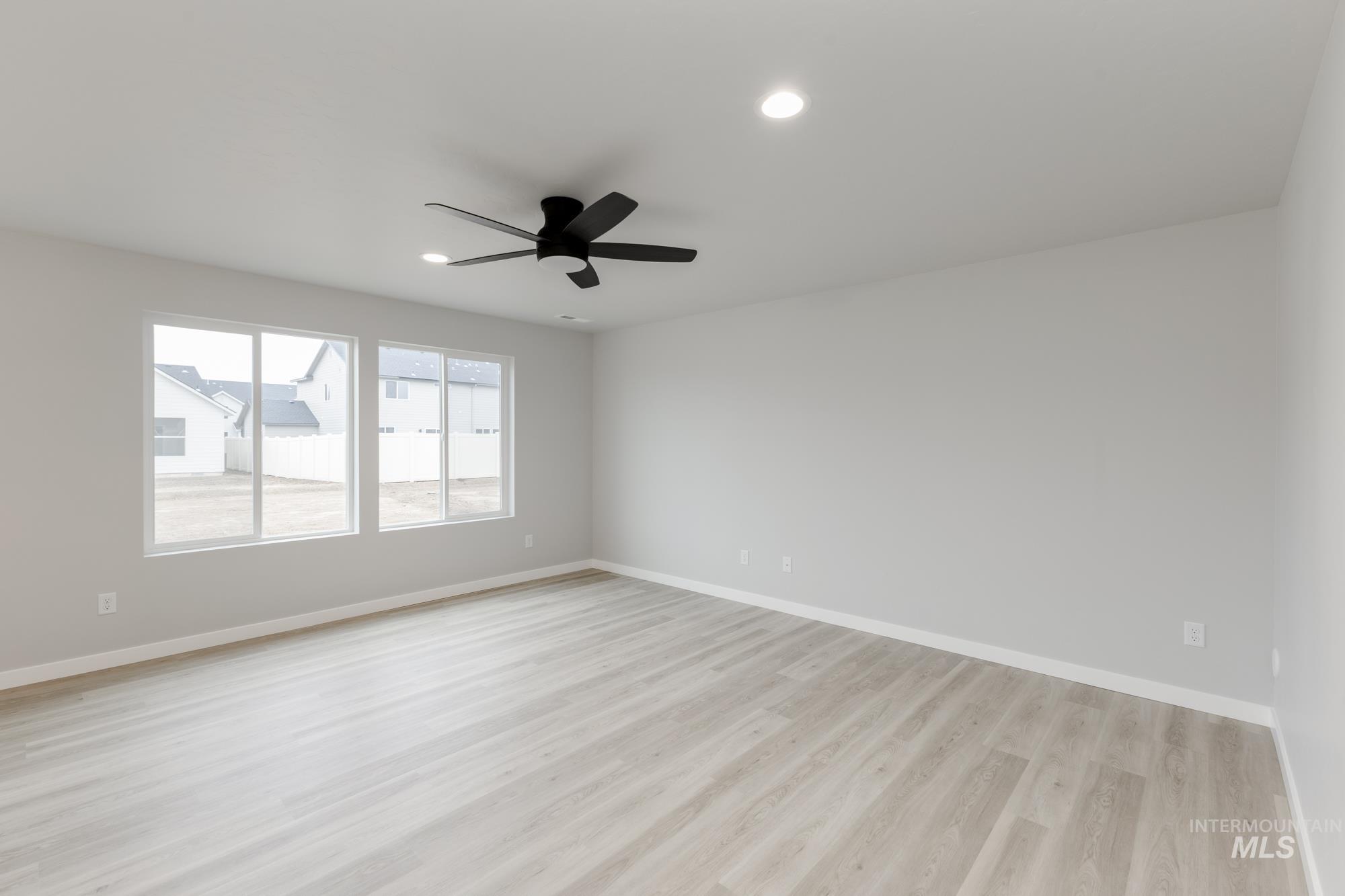 13743 Judson Street Caldwell, ID 83607 - Photo 6 of 23 Empty room with light wood finished floors, recessed lighting, and ceiling fan