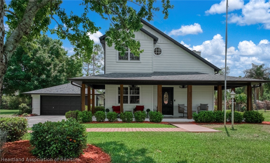 a front view of a house with a yard and porch
