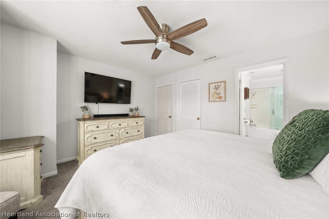3103 Duffer Road Sebring, FL 33872 - Photo 14 of 29 a bedroom with a bed and a flat screen tv