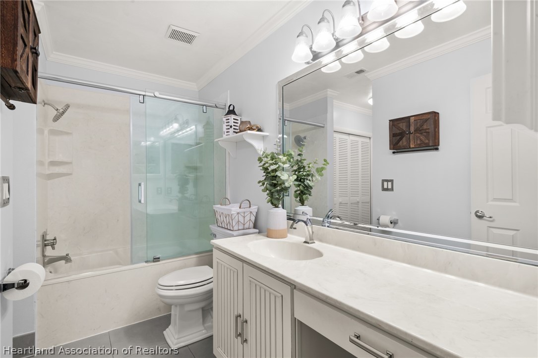 3103 Duffer Road Sebring, FL 33872 - Photo 15 of 29 a bath room with a toilet a sink and a large mirror