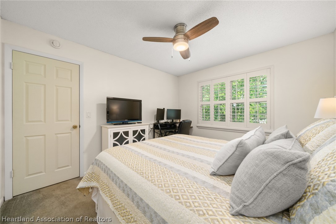 3103 Duffer Road Sebring, FL 33872 - Photo 19 of 29 a bedroom with a bed and a flat screen tv