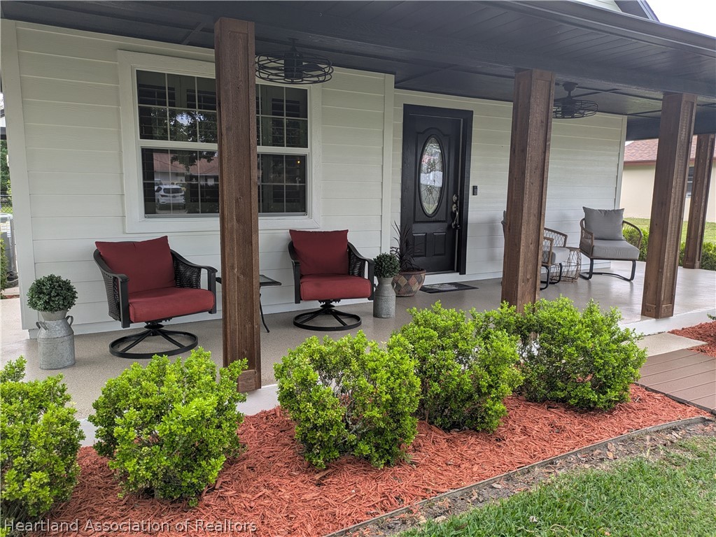 3103 Duffer Road Sebring, FL 33872 - Photo 26 of 29 a front view of a house with garden and sitting area