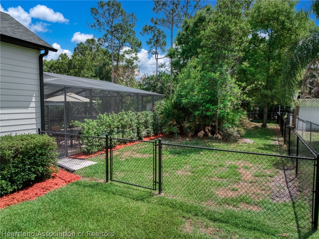 3103 Duffer Road Sebring, FL 33872 - Photo 27 of 29 a view of a backyard with plants and a large tree