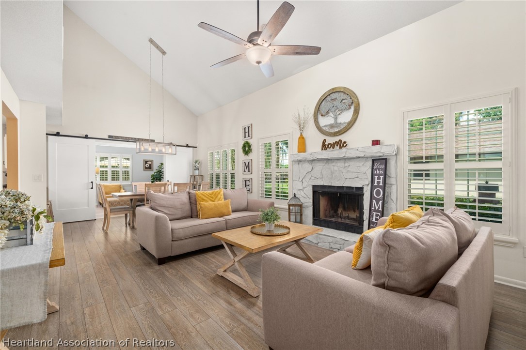3103 Duffer Road Sebring, FL 33872 - Photo 10 of 29 a living room with furniture a clock and a fireplace