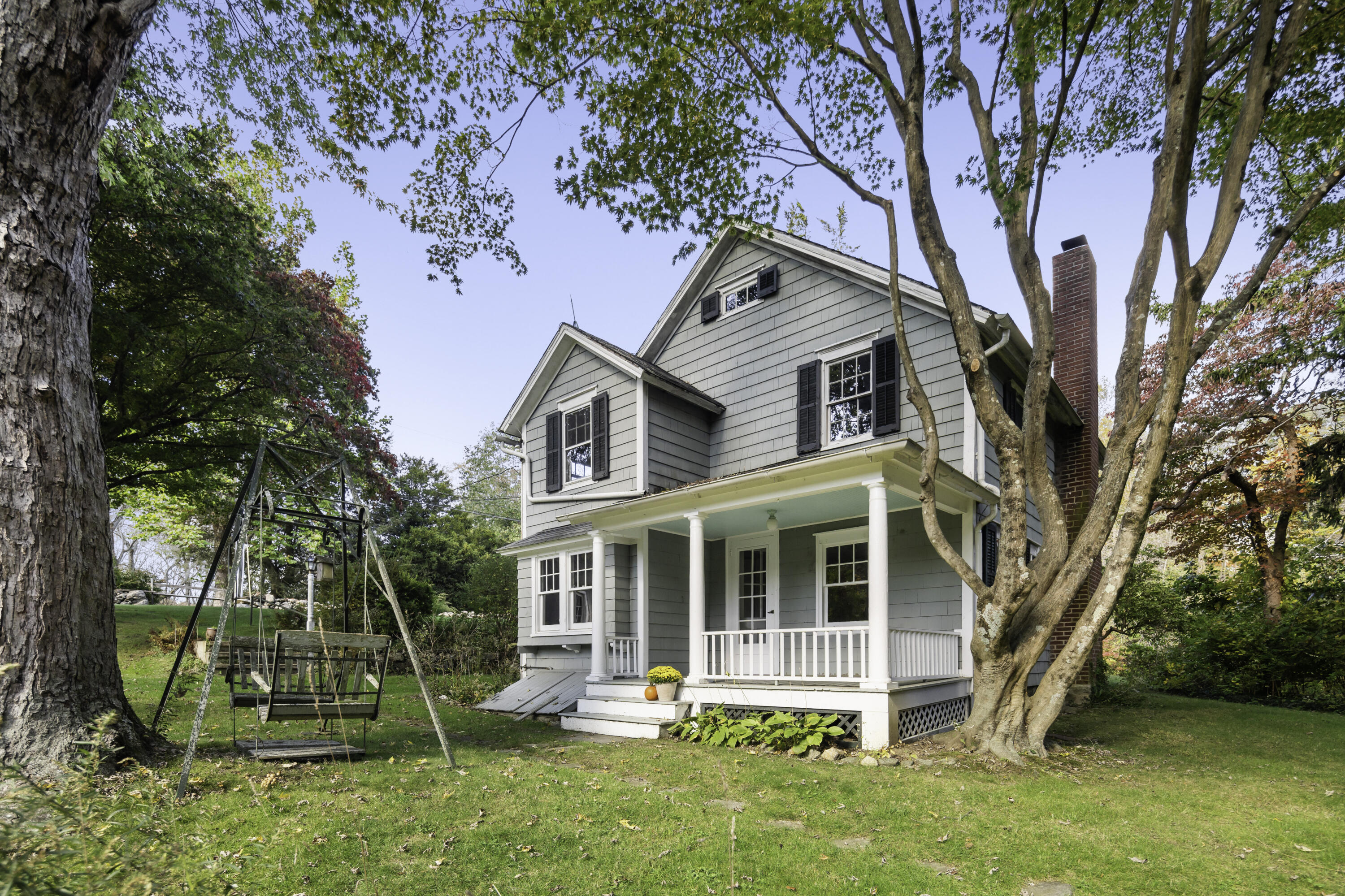 40 Ogden Road New Canaan, CT 06840 - Photo 1 of 35 a view of a house with backyard porch and sitting area