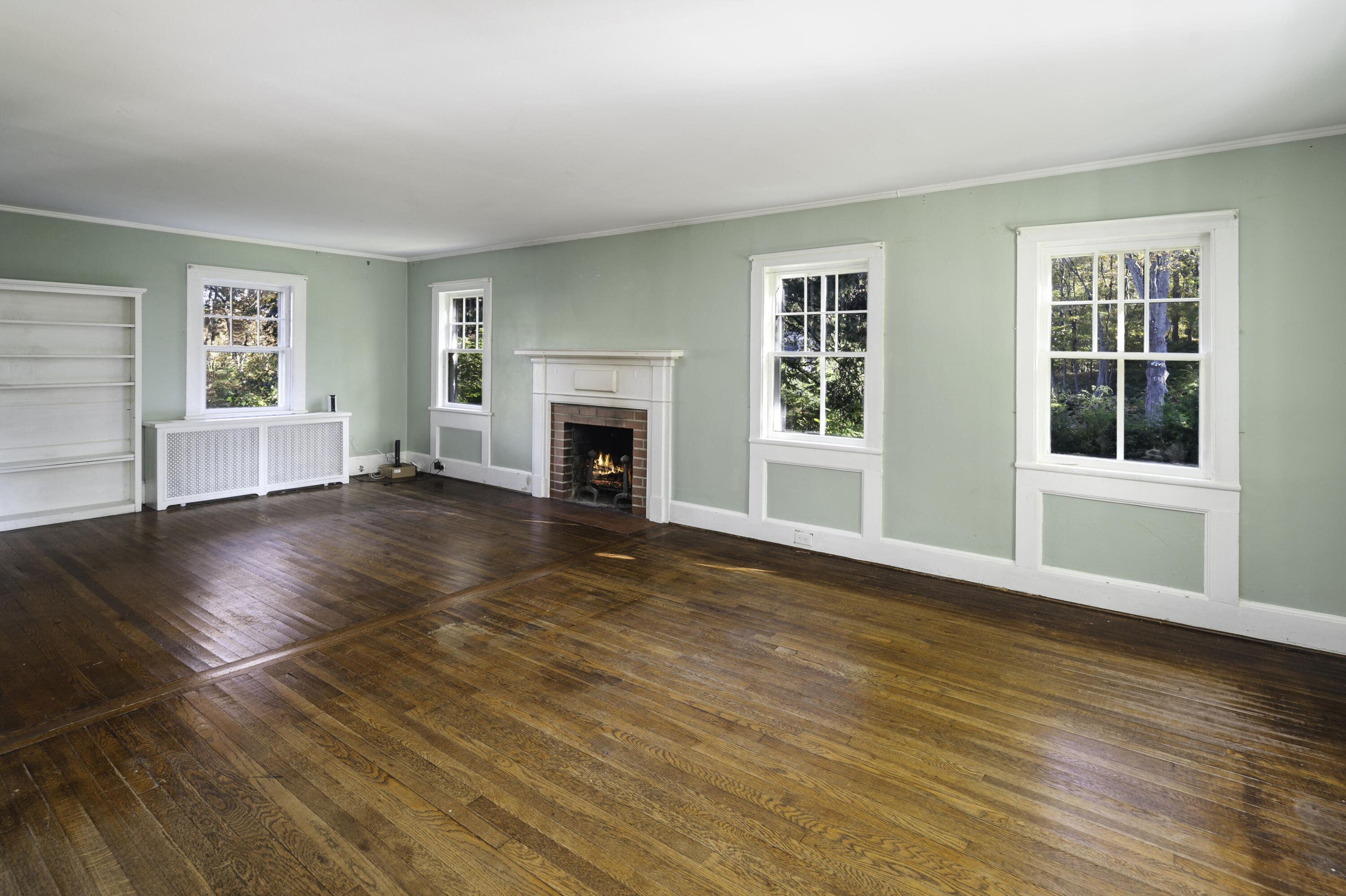 40 Ogden Road New Canaan, CT 06840 - Photo 6 of 35 a view of empty room with wooden floor and fireplace