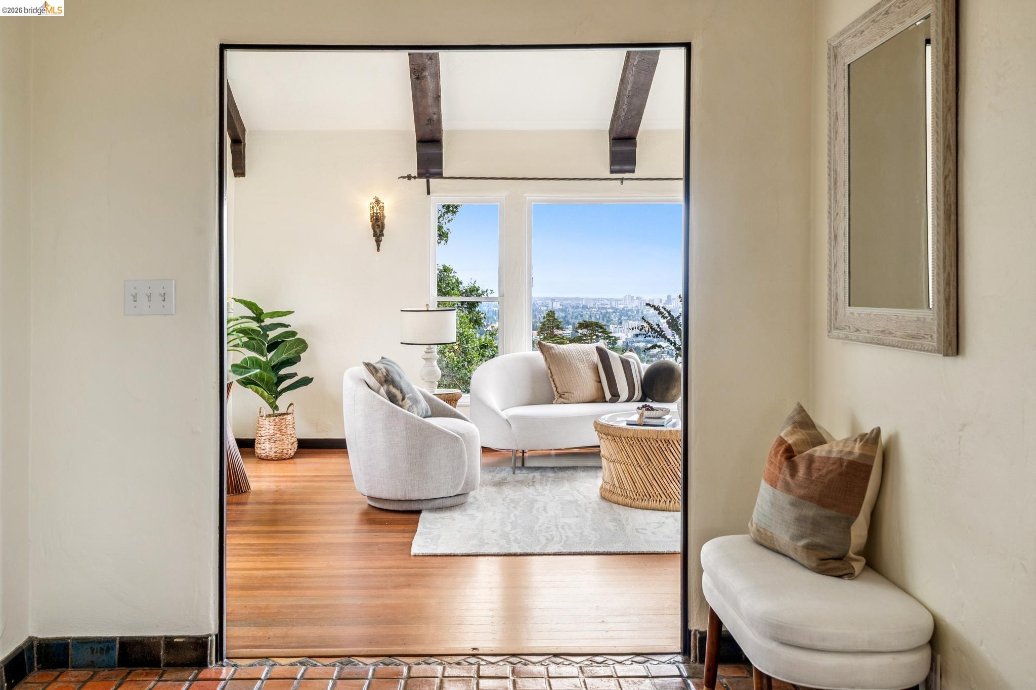 784 Cragmont Avenue Berkeley, CA 94708 - Photo 14 of 64 Bright living space with large picture windows, exposed wood ceiling beams, hardwood flooring, and a decorative wall sconce