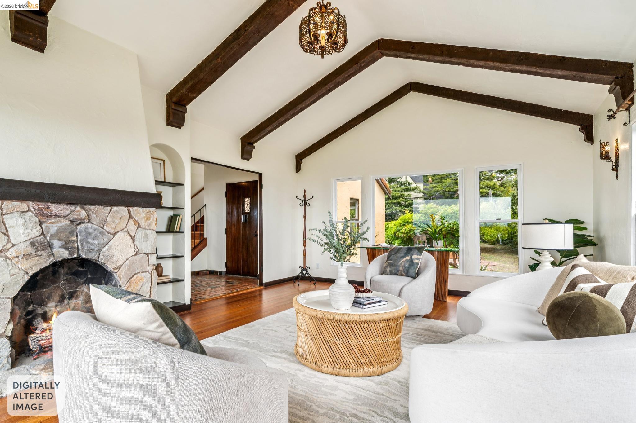 784 Cragmont Avenue Berkeley, CA 94708 - Photo 20 of 64 Spacious living area featuring a vaulted ceiling with exposed wood beams, a stone-clad fireplace, and hardwood flooring