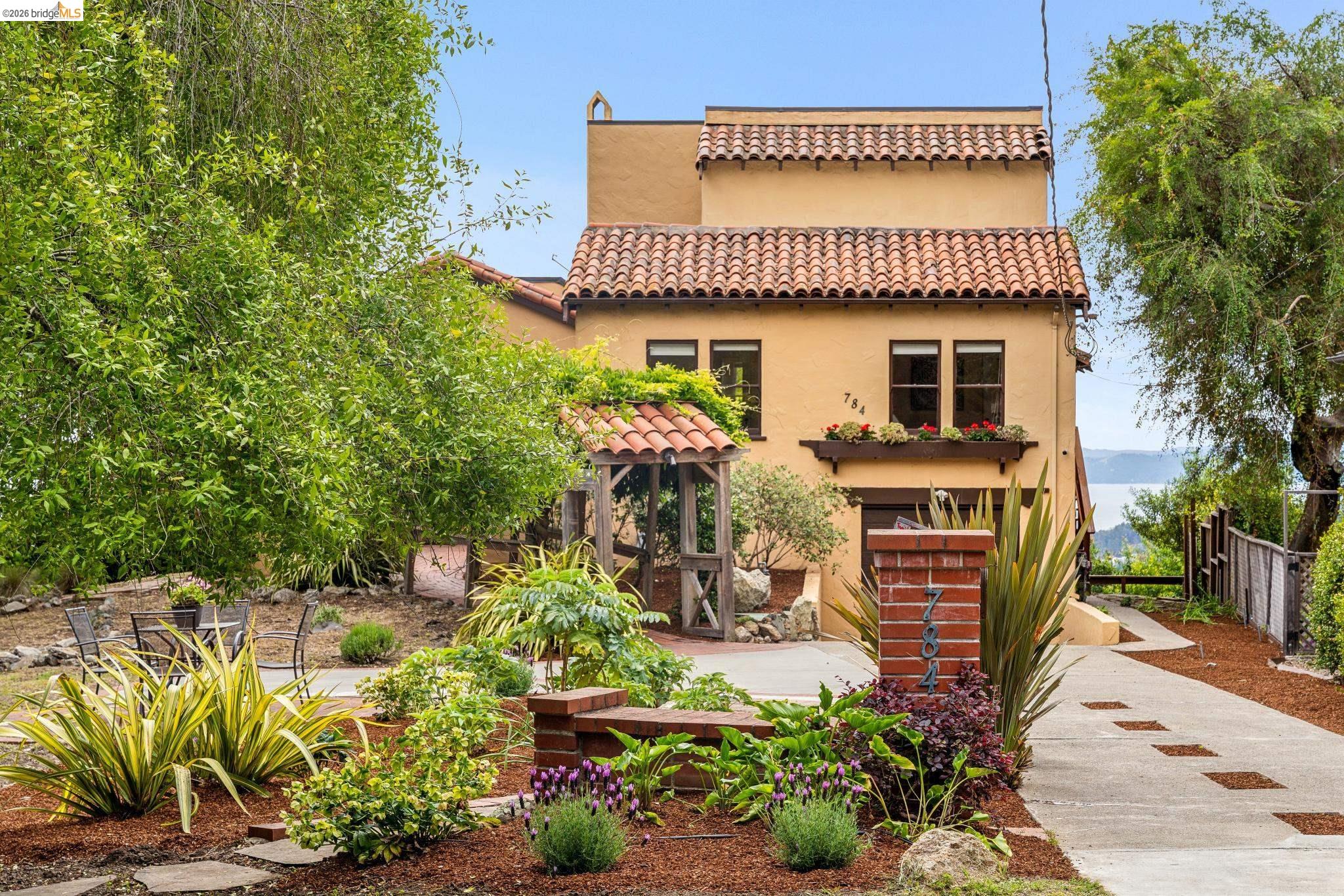 784 Cragmont Avenue Berkeley, CA 94708 - Photo 5 of 64 Mediterranean-style residence featuring a terracotta tile roof, stucco exterior, and multi-pane windows