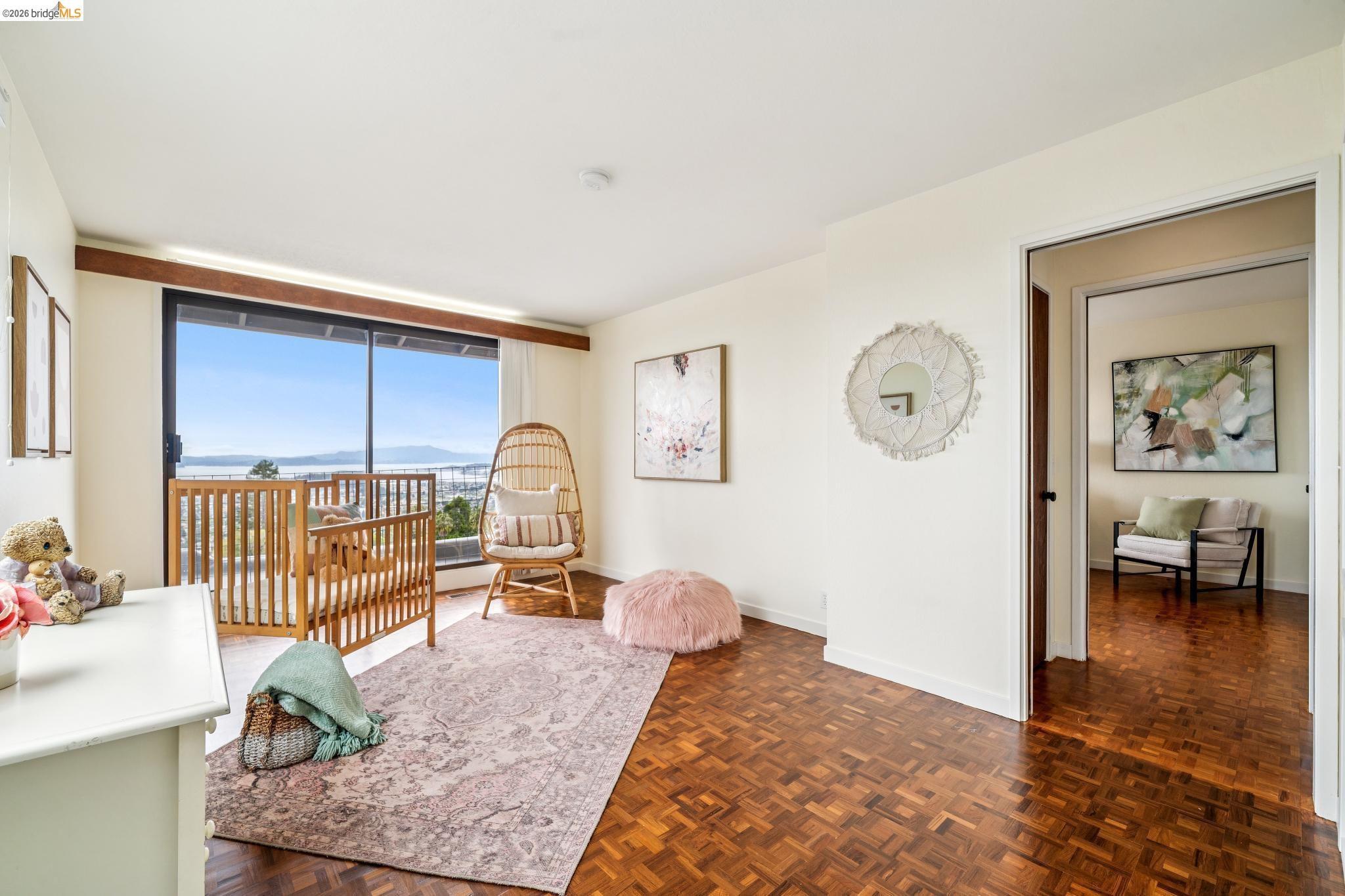 784 Cragmont Avenue Berkeley, CA 94708 - Photo 56 of 64 Room with wood-finish parquet flooring, a large sliding glass door, and a light-colored wall finish