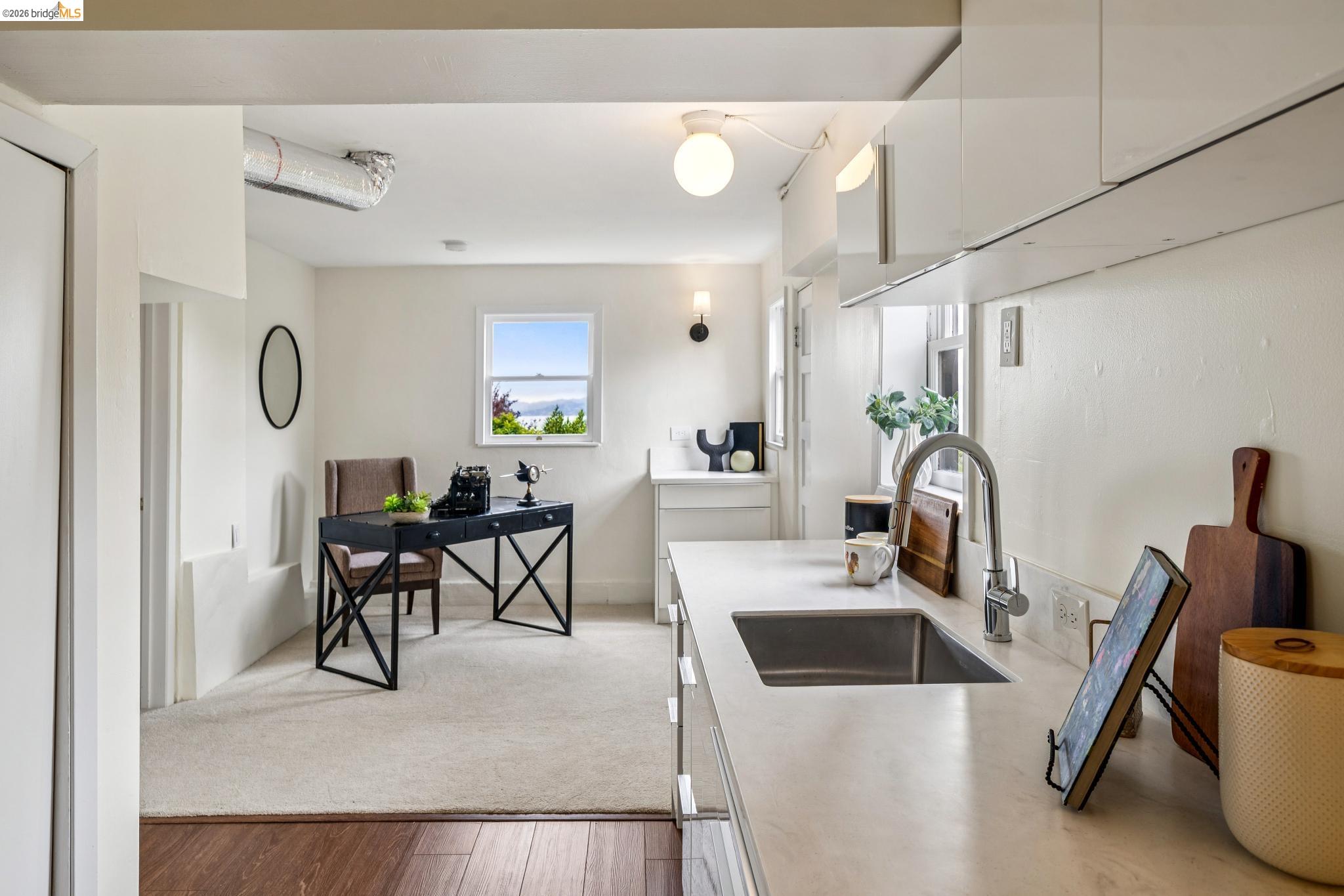784 Cragmont Avenue Berkeley, CA 94708 - Photo 59 of 64 Kitchenette featuring white cabinetry and light-toned countertops with an integrated sink and gooseneck faucet