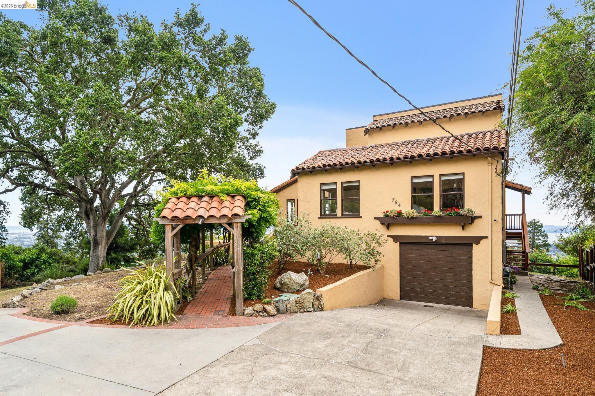 784 Cragmont Avenue Berkeley, CA 94708 - Photo 6 of 64 Stucco exterior residence featuring a terracotta tile roof and wood-finish garage door