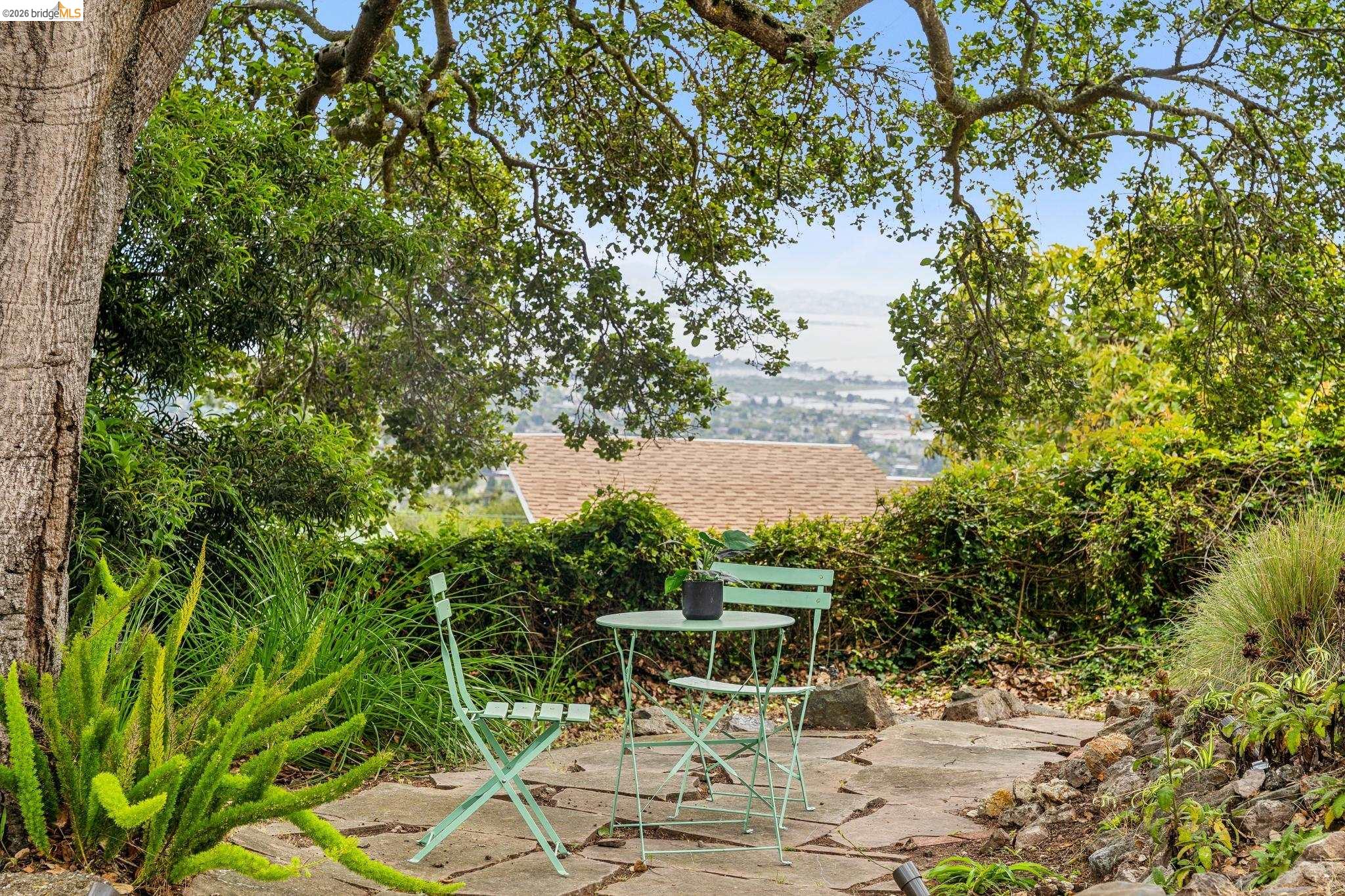 784 Cragmont Avenue Berkeley, CA 94708 - Photo 7 of 64 Terraced outdoor area featuring natural stone paving, established trees, and diverse plantings