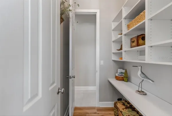 a living room with furniture a chandelier and a dining table