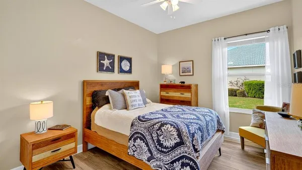 a living room with furniture and a view of kitchen
